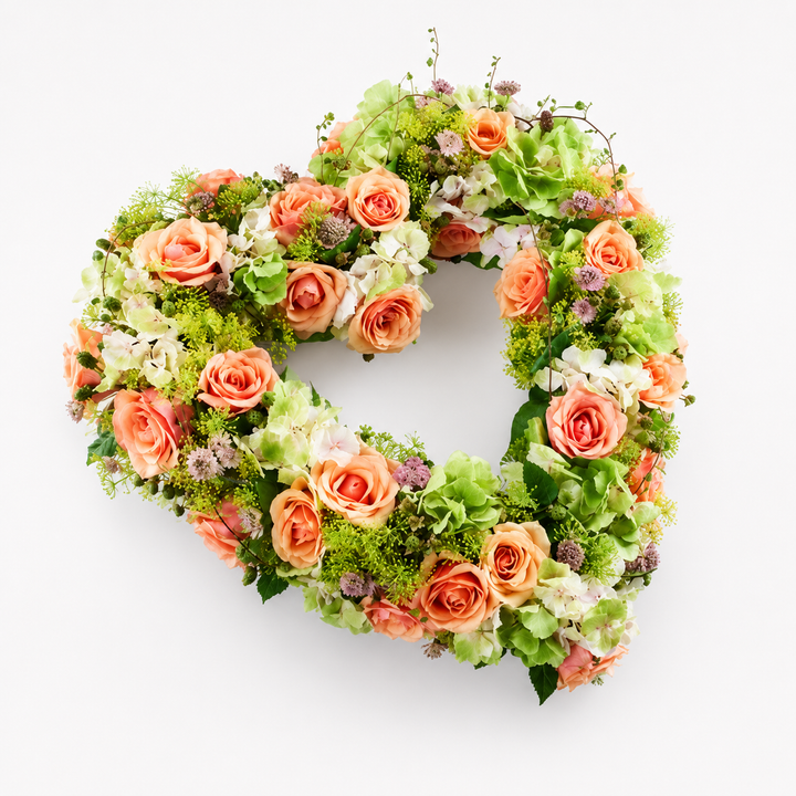 Soft Pastel Heart Funeral Tribute heart shaped funeral flowers delivered in Denmark